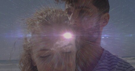 Leaning couple closing eyes, hair tied, man wearing striped tee at beach star flare ocean-horizon