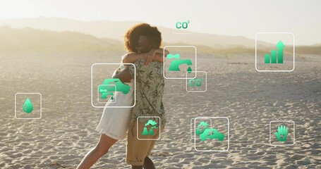 Embracing couple wrapping arms on beach, woman sundress, man leafy shirt khaki shorts, green icons