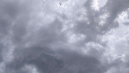 Fototapeta premium Dark overcast sky filled with heavy grey cumulus clouds before a rainstorm.
