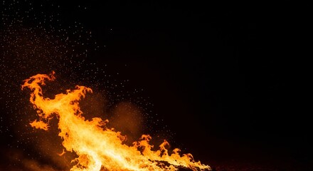 Vibrant orange flames burning brightly against a dark background