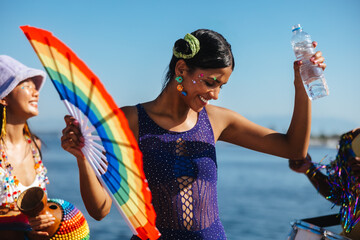 Dancing at Brazilian carnival with rainbow fan