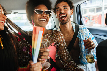 Friends celebrate in car during carnival