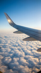 Obraz premium Airplane Wing Above Clouds at Golden Hour, Serene Aerial View