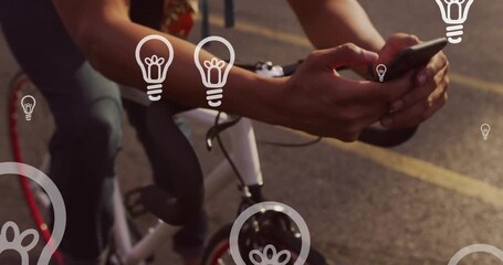 Animation of light bulb icons and data processing over caucasian man using smartphone - Powered by Adobe