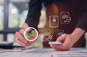 Businessman use pen review paper data charts and digital documents, utilizing intelligent management system to validate records and streamline final approvals workflow and quality assurance