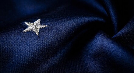 Close up of a single star on dark blue fabric