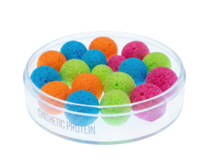 Colorful synthetic protein spheres arranged in a clear container, showcasing vibrant hues of blue, green, orange, and pink.
