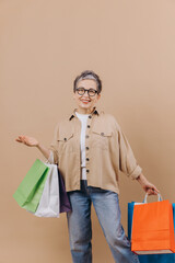 Mature woman enjoying retail therapy with shopping bags