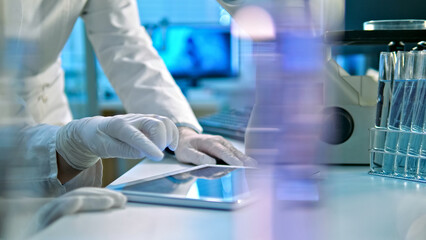 A scientist in a lab coat and gloves examines a document, surrounded by advanced lab equipment,...