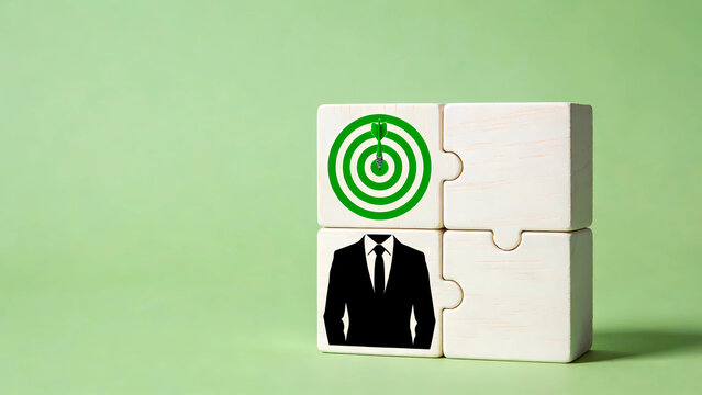 Business strategy and goal achievement concept with target and businessman icon on white wooden puzzle blocks, leadership and team building metaphors on green background