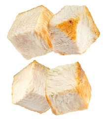arrangement of four perfectly cooked, tender white chicken breast cubes, displaying their moist texture and attractive seared golden-brown edges, set against a clean transparent background.