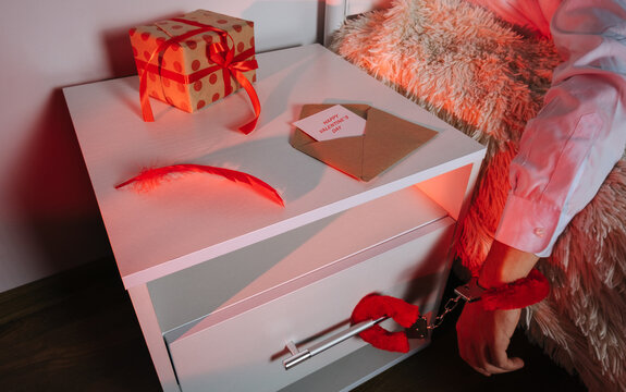 Valentine's Day still life with gift handcuffs and romantic objects