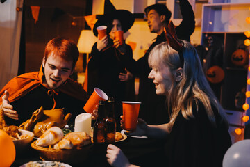 Friends enjoying a Halloween party at a bar making a toast