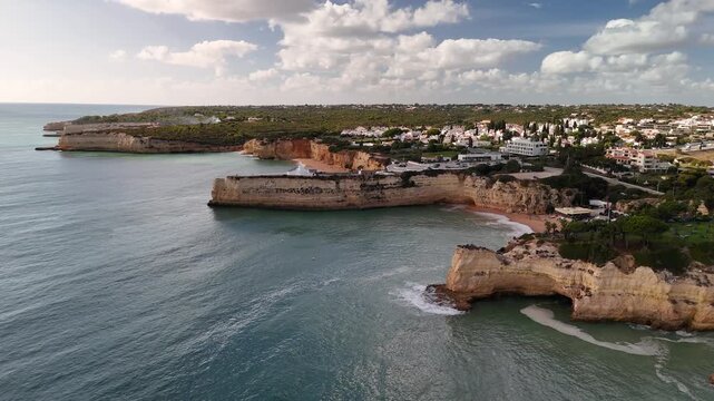 High Angle Drone Approach Towards the White-Washed Chapel of Nossa Senhora da Rocha Built on a Rocky Limestone Promontory Overlooking the Ocean in the Algarve Region of Portugal