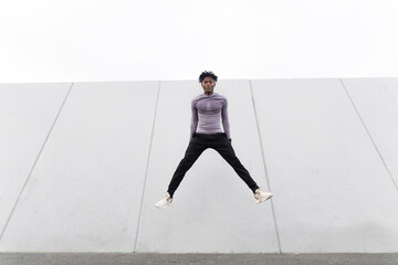 Athlete jumping outdoors in urban setting showing fitness and motivation