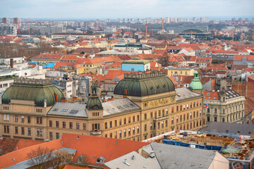 Naklejka premium Wide panoramic view over Zagreb’s historic city center with ornate buildings and dense red rooftops under soft winter light