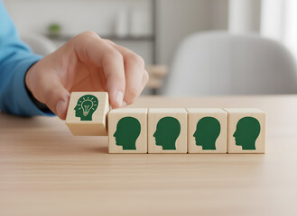 A hand placing a wooden block with a green silhouette on a table