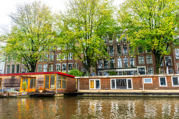 Amsterdam Canal with Houseboat and Traditional Buildings
