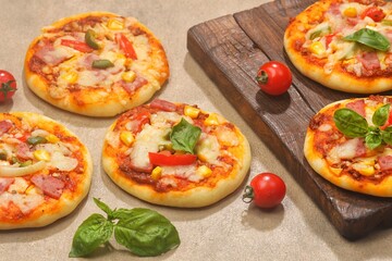 Homemade mini pizzas with smoked beef, tomatoes and mozzarella cheese