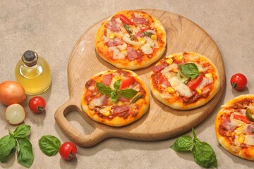 Homemade mini pizzas with smoked beef, tomatoes and mozzarella cheese