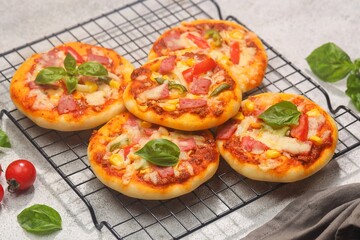 Homemade mini pizzas with smoked beef, tomatoes and mozzarella cheese