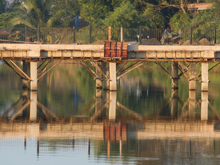 The bridge across the pond in the morning is under construction.