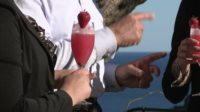 A red cocktail in a hand