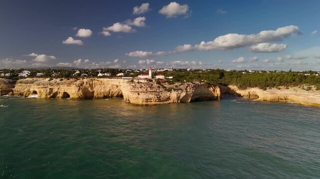 Aerial Orbit of Farol de Alfanzina Lighthouse on Algarve Coast Sandstone Cliffs Portugal