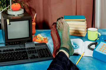 Businessman relaxing at colorful vintage office desk with feet up