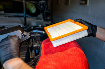 Auto mechanic replacing air conditioner filter. Car care maintenance servicing concepts. High quality photo