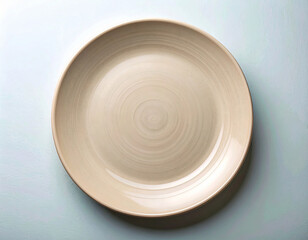 Classic elegance. Ceramic plate with a classic beige design on a white background. Porcelain kitchenware. Close-up. Top view.