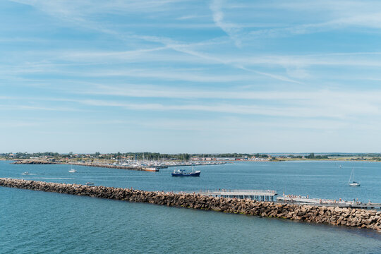 Elevated view of Varberg harbor entrance with breakwater, distant Getter&ouml;n island and a ship, Sweden