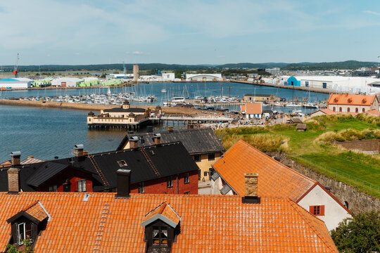 High angle view of Varberg cityscape with red rooftops, the historic Cold Bath House and harbor, Sweden