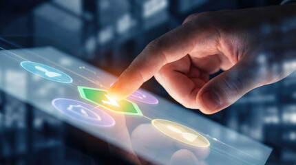 A finger touches a brightly illuminated screen displaying abstract shapes and colors with a dark background behind the hand