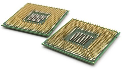 Two CPU processors with gold pins isolated on white