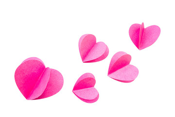 pink heart-shaped paper flying against a white isolated background