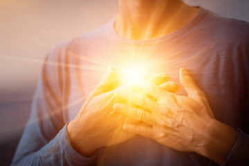 Emotional healing inner peace awellness journey concept. A warm, glowing light emanates from a person's chest in comfort