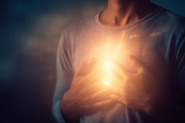 Emotional healing inner peace awellness journey concept. A warm, glowing light emanates from a person's chest in comfort
