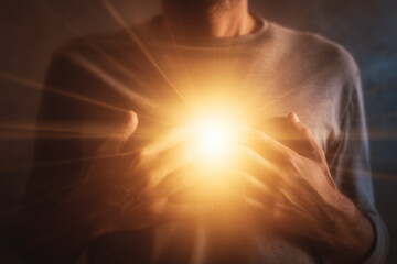 Emotional healing inner peace awellness journey concept. A warm, glowing light emanates from a person's chest in comfort