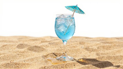 Blue cocktail with umbrella on sandy beach