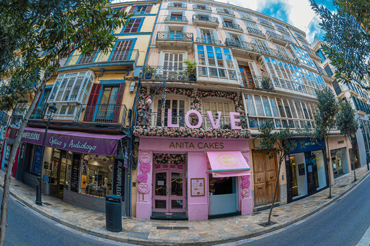 Cheerful decorations on the facade of a house-confectionerie on the narrow street Carrer de Colom, in the old town, Palma de Mallorca, Spain