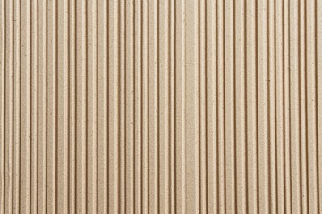 Obraz premium A textured surface featuring vertical lines, creating a rhythmic pattern in a neutral beige color.