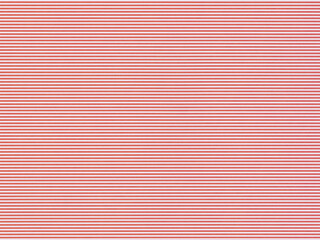 Lined paper featuring evenly spaced horizontal lines across the entire sheet. The lines are white with a red background. The texture is smooth, typical of regular writing paper.