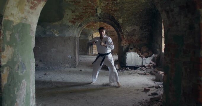 Karateka uses nunchaku and kicks in combat for self-defense. A young karateka demonstrates various types of punches and kicks used in karate.