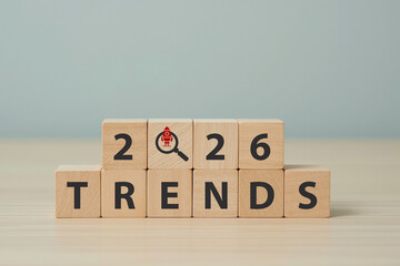 2026 trends, emerging markets concept. Wooden cube blocks with 2025, magnifying glass, TRENDS text. Used for banner in trend concept in new year for monitoring new business opportunities