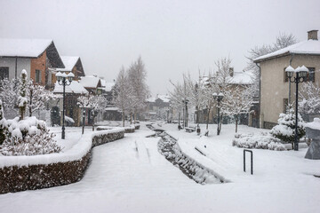 Small bulgarian town in the winter snowy day. Gotse Delchev street, a kempt pedestrian street in city center.