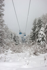 Gondola ski lift in winter snowy day. Cable lift in Bansko ski resort.
