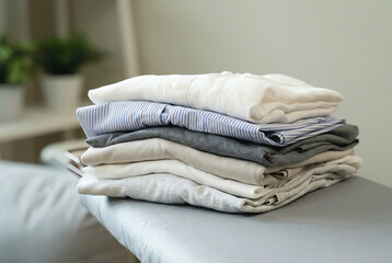 Stack of Folded Towels on Bed.