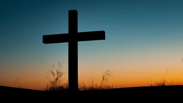 Silhouette of a cross against a beautiful sunset sky, peaceful scene.