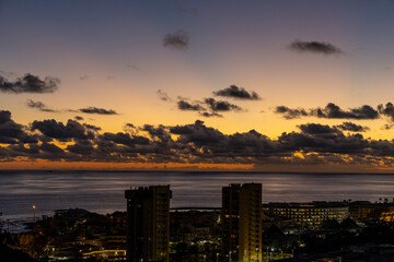 Sunset over the Atlantic Ocean and the town of Las Americas, Tenerife, Canary Islands.